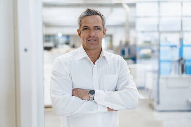 Portrait of a confident businessman in a factory - DIGF09262