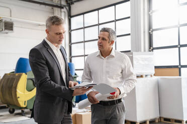 Two businessmen talking in a factory - DIGF09267