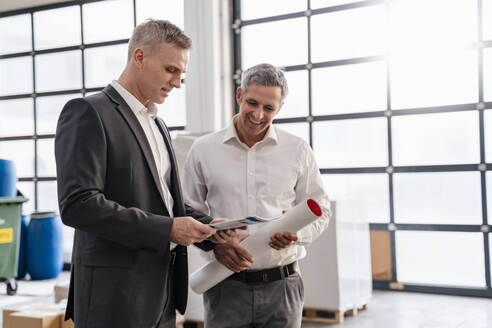 Two businessmen talking in a factory - DIGF09268