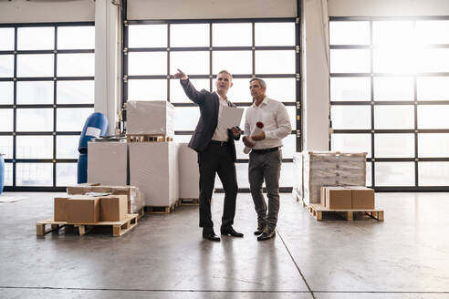 Two businessmen talking in a factory - DIGF09269