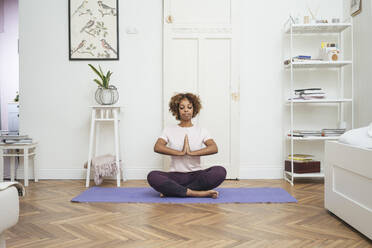 Young woman practicing yoga at home - VPIF01941