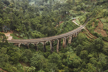 Sri Lanka, Uva Province, Demodara, Aerial view of Nine Arch Bridge across green forested valley - DAWF01111