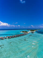 Maldives, Aerial view of resort stilt houses on Maadhoo island in summer - AMF07707