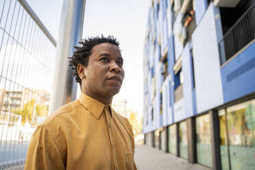 Portrait of mature man wearing yellow shirt - AFVF05003