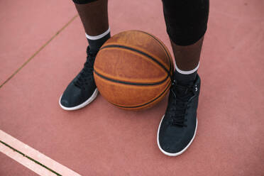 Basketball between feet of basketball player - GRCF00057