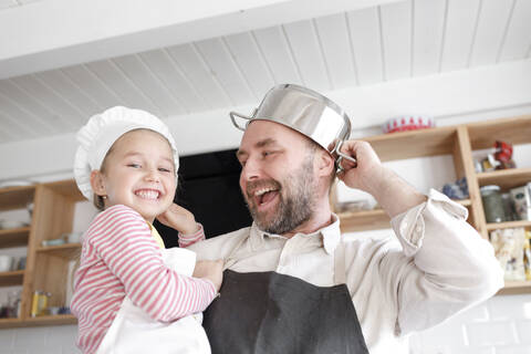 Father and daughter cooking in the kitchen stock photo