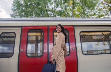 Young woman taking the commuter train - AJOF00127