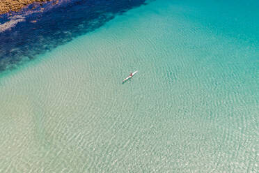 Aerial view of man with kayak over transparent water, South Africa. - AAEF06348