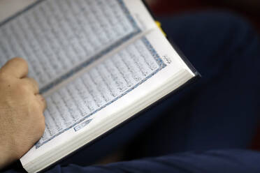 Close-up of Muslim man reading the Noble Quran, Hanoi, Vietnam, Indochina, Southeast Asia, Asia - RHPLF13431