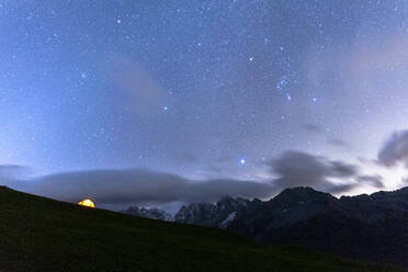 Camping tent under the stars facing Piz Badile and Piz Cengalo, Tombal, Soglio, Val Bregaglia, Canton of Graubunden, Switzerland, Europe - RHPLF13452