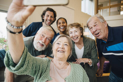 Ältere Frau macht Selfie mit Freunden und Pflegepersonal im Altersheim - MASF16205