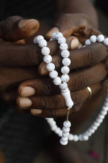 Close-up of hands of African Muslim man praying with Islamic prayer beads (tasbih), Togo, West Africa, Africa - RHPLF13498