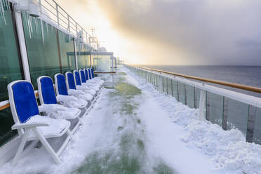 Cruise ship on an Arctic Winter voyage, fresh powder snow on decks, off Troms County, North Norway, Scandinavia, Europe - RHPLF13559