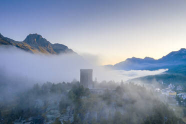 Aerial view by drone of mist over Torre Belvedere in autumn, Maloja Pass, Engadine, Canton of Graubunden, Switzerland, Europe - RHPLF13586