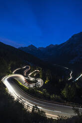 Light trails on the hairpin curves of Maloja Pass mountain road at night, Engadine, Canton of Graubunden, Switzerland, Europe - RHPLF13589