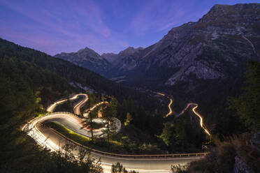 Car trails lights on narrow bends of Maloja Pass mountain road, Engadine, Canton of Graubunden, Switzerland, Europe - RHPLF13590