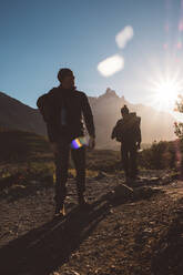 Backpackers walking in mountains in sunny day - CAVF72711