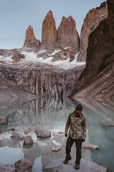 Happy hiker in mountains near calm lake - CAVF72734