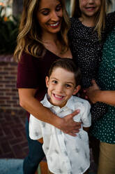 Mom Embracing Young Son While Smiling at Camera - CAVF72757