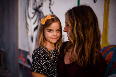 Mom Looking at Daughter as Daughter Smiles for Camera - CAVF72760