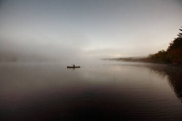 Solo paddling on a misty pond at sunrise. - CAVF72854