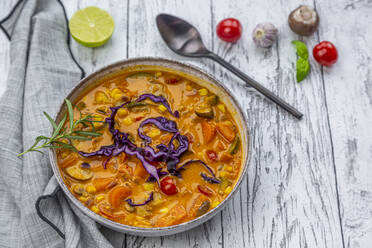 Bowl of potato curry on wooden table - SARF04418