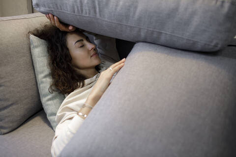 Portrait of woman relaxing on the couch stock photo
