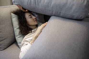 Portrait of woman relaxing on the couch - KMKF01177