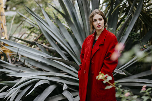 Woman with red coat in a park - TCEF00001