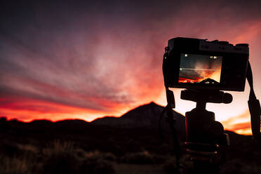 Spain, Tenerife, Camera on tripod in landscape at sunset - SIPF02116