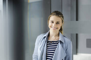 Female student at corridor of office building - CUF54472