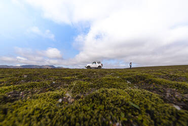 Hiker exploring mossy landscape, Landmannalaugar, Highlands, Iceland - CUF54531