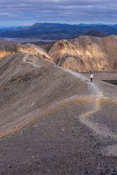 Woman on ridge of hill, Landmannalaugar, Iceland - CUF54565