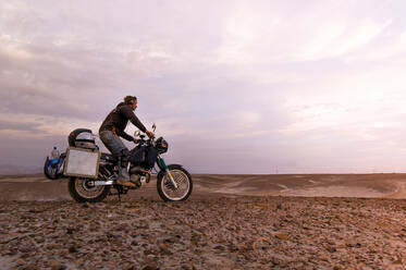 Motorcyclist enjoying view in desert, Arequipa, Peru - ISF23716