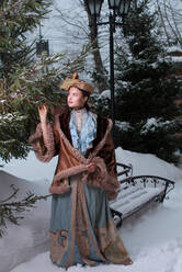 Beautiful Russian woman in a vintage dress. Russian village. Winter. - CAVF73228