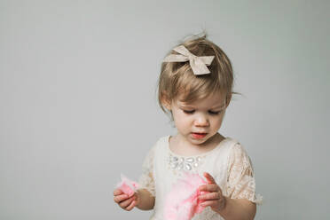 Toddler eating pink cotton candy - CAVF73249