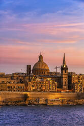 Malta, Valletta, City skyline at sunset, boats in Marsamxett Harbour in foreground - ABOF00457
