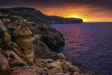 Malta, Rocky shore of Mediterranean Sea at sunrise - ABOF00508