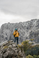 Hiker on viewpoint at Laghi di Fusine, Friuli Venezia Giulia, Italy - MAUF03207