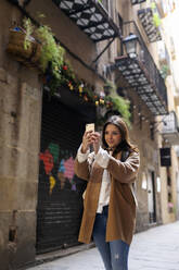 Young woman taking a selfie in the city, Barcelona, Spain - VABF02535