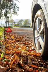 Germany, Lindenfels, Close-up of broken car on roadside - PUF01860