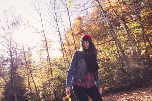 Woman wearing red woolly hat and denim jacket - DHEF00017