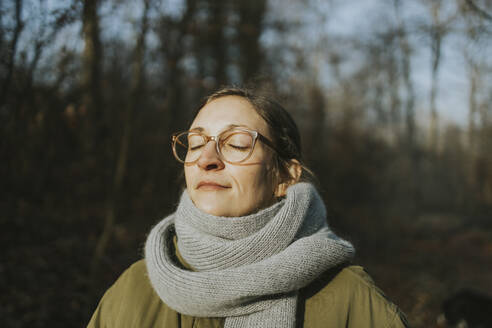 Porträt einer Frau während eines Sonnenbads im Winter - DWF00543
