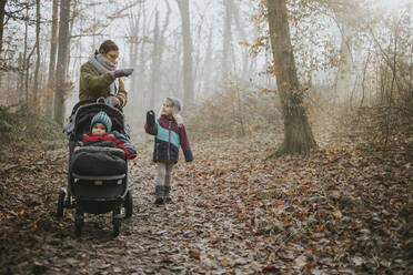 Mother with daughters during forest walk in autumn - DWF00545