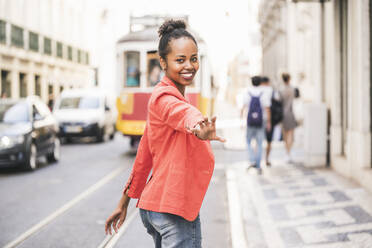 Portrait of happy young woman in the city, Lisbon, Portugal - UUF20134