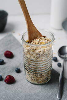 Wooden spoon in jar of granola - JMHMF00034