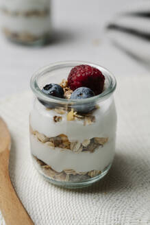 Small jar of granola with yogurt, blueberries and raspberry - JMHMF00036