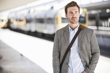 Portait of confident young businessman at the train station - UUF20142