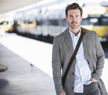 Portait of confident young businessman at the train station - UUF20143