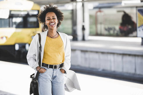 Laughing young woman at the train station - UUF20156